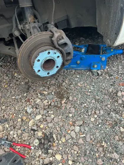 Brake disc and caliper inspected with the wheel removed