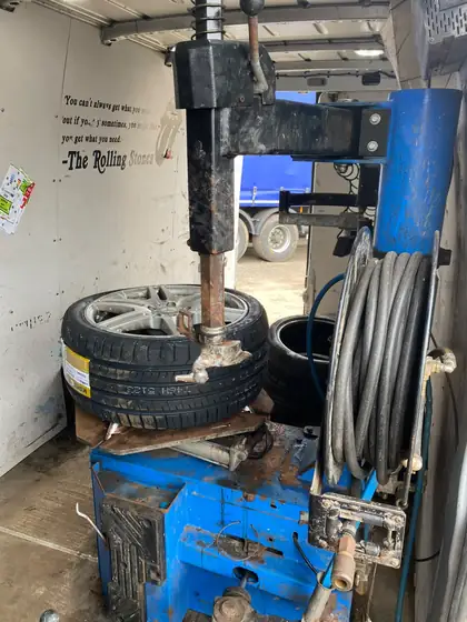 New tyre being fitted to an alloy wheel on the tyre changer
